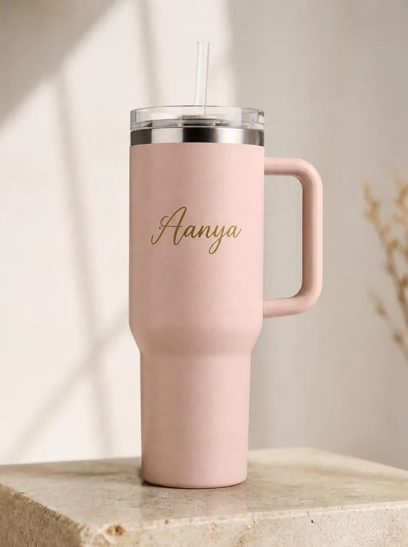 A blush tumbler with the name Aanya in gold script